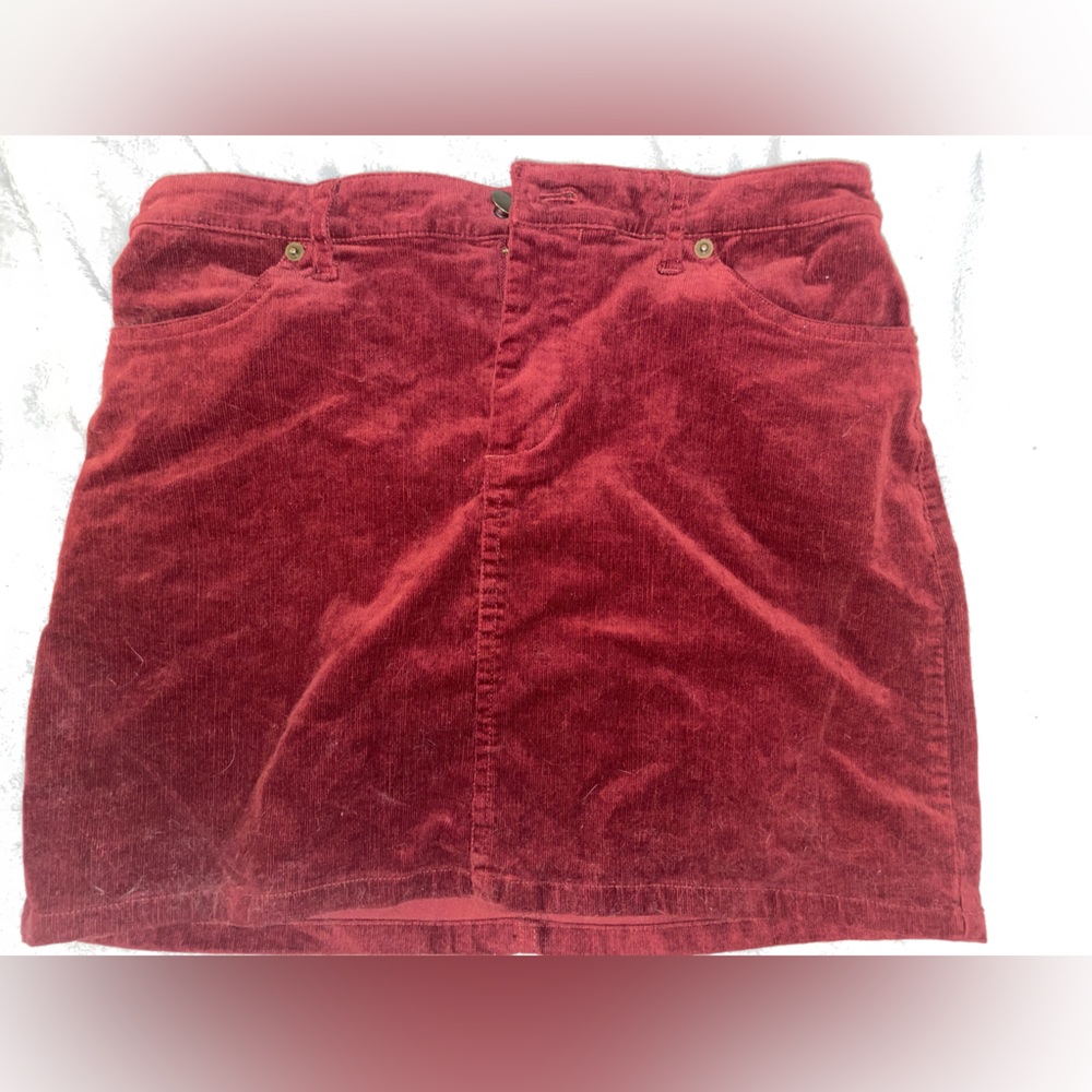 mini skirt.  size 4. red velvet material, buttons and zipper. two front pockets